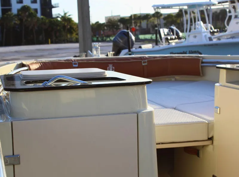 Slide: The Image of 2024 Capoforte SX200 boat interior with seating and deck, docked at marina. - 16