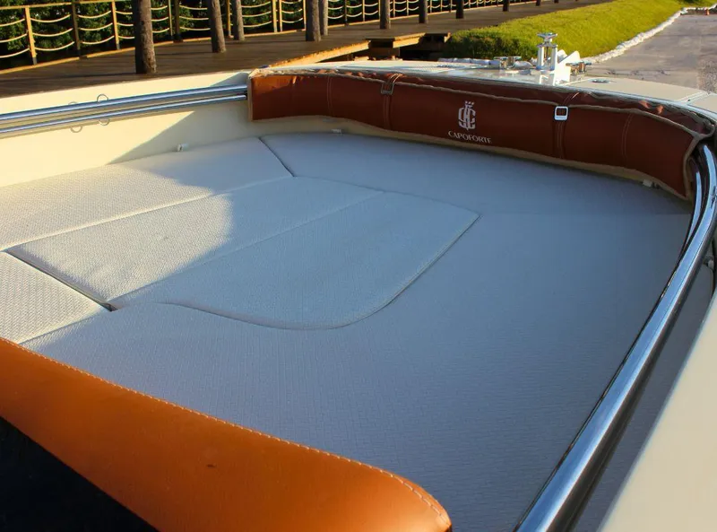 Slide: The Image of 2024 Capoforte SX200 boat interior with cushioned seating and elegant design. - 17