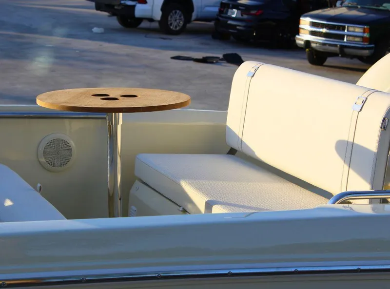 Slide: The Image of 2024 Capoforte SX200 boat interior with seating and a small round table. - 6