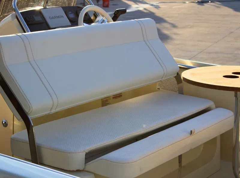 Slide: The Image of 2024 Capoforte SX200 boat interior with white seating and a small table. - 7