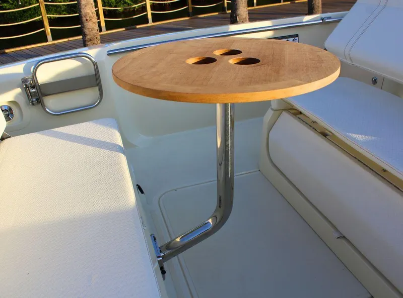 Slide: The Image of 2024 Capoforte SX200 boat interior with a wooden table and seating area. - 8
