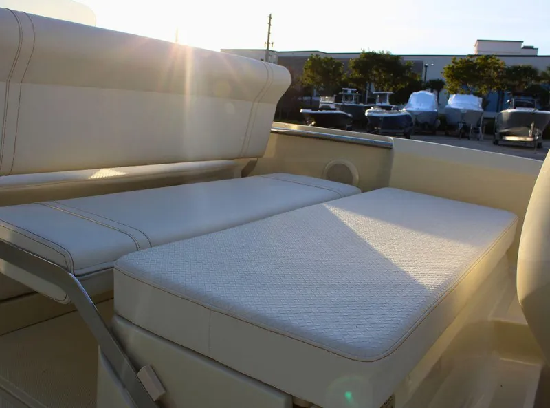 Slide: The Image of 2024 Capoforte SX200 boat interior with sunlit seating area. - 9