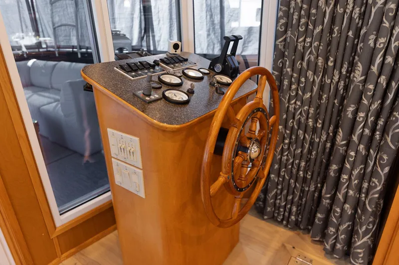 Slide: The Image of Steering console of 2011 Horizon 18 X 82 Houseboat with wooden wheel and gauges. - 15