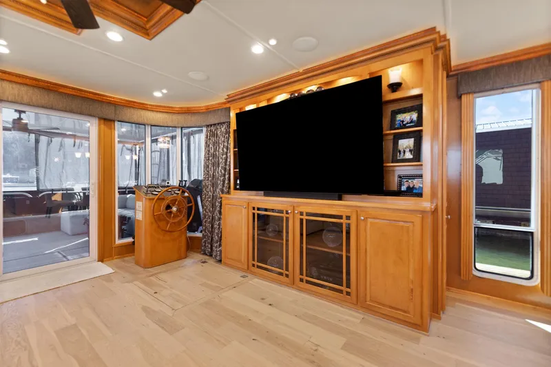 Slide: The Image of Luxurious interior of 2011 Horizon 18 X 82 houseboat with wood cabinetry and large TV. - 17