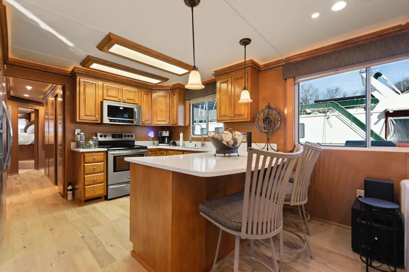 Slide: The Image of Luxurious kitchen interior of 2011 Horizon 18 X 82 Houseboat with wooden cabinetry and modern appliances. - 20