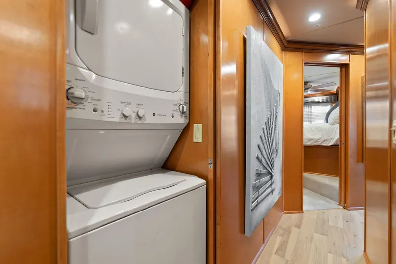 Slide: The Image of Laundry area in 2011 Horizon 18 X 82 houseboat with wood paneling and hallway view. - 29