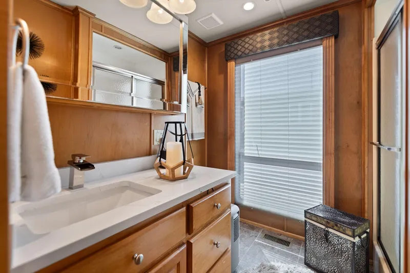 Slide: The Image of Luxurious bathroom in 2011 Horizon 18 X 82 houseboat with wooden cabinetry and modern fixtures. - 30