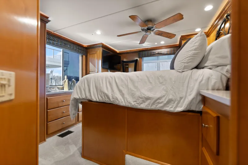 Slide: The Image of Luxurious bedroom interior of 2011 Horizon 18 X 82 houseboat with ceiling fan and wooden cabinetry. - 33