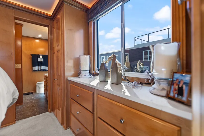 Slide: The Image of Interior of 2011 Horizon 18 X 82 Houseboat with wooden cabinets and decorative items. - 35