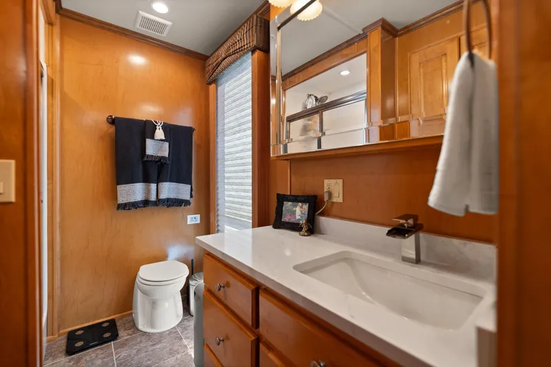 Slide: The Image of 2011 Horizon 18 X 82 Houseboat bathroom with wooden cabinetry and modern fixtures. - 37