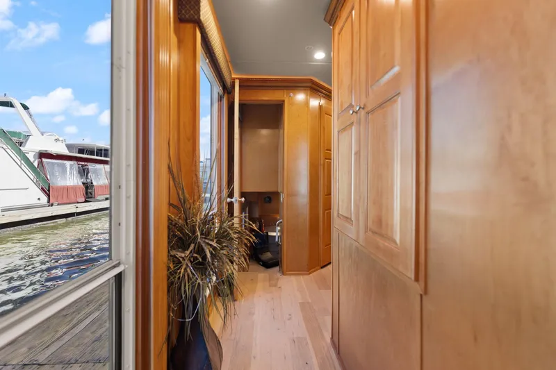 Slide: The Image of Interior hallway of 2011 Horizon 18 X 82 Houseboat with wooden cabinets and large window. - 40