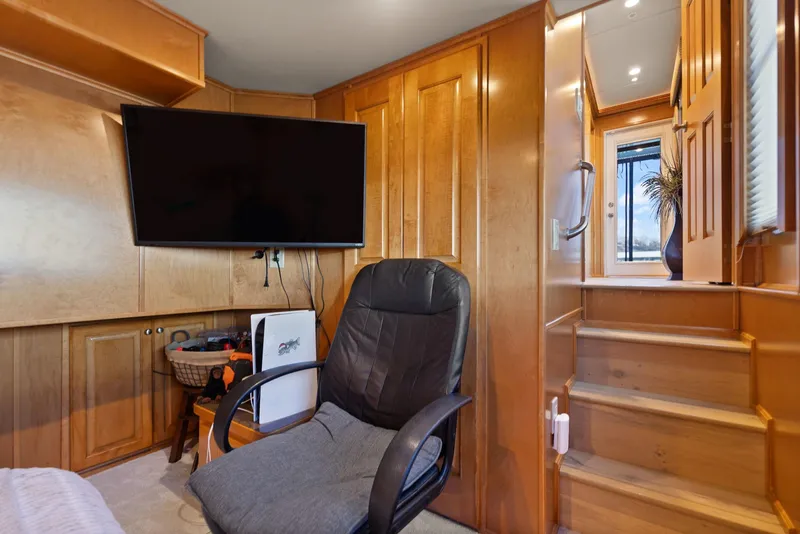 Slide: The Image of Interior of 2011 Horizon 18 X 82 Houseboat with TV, chair, and wooden stairs. - 44