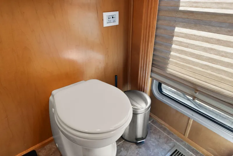 Slide: The Image of Houseboat bathroom with toilet, trash can, and window blinds, Horizon 18 X 82, 2011 model. - 46