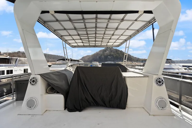 Slide: The Image of 2011 Horizon 18 X 82 Houseboat deck with covered seating and scenic marina view. - 47