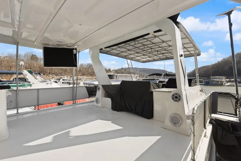 Slide: The Image of 2011 Horizon 18 X 82 Houseboat deck with covered seating and scenic marina view. - 48