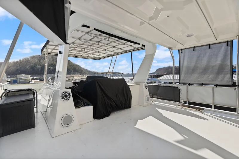 Slide: The Image of 2011 Horizon 18 X 82 Houseboat deck with canopy and scenic view. - 49