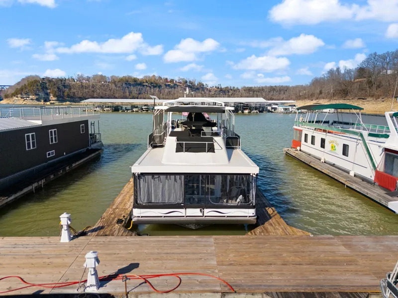 Slide: The Image of 2011 Horizon 18 X 82 houseboat docked on a sunny day, surrounded by other boats. - 5