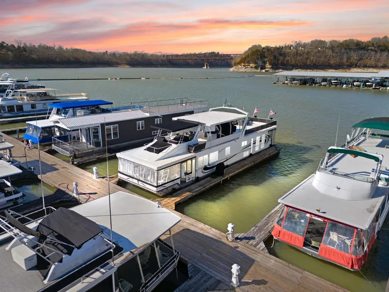 Slide: The Image of Houseboats docked at sunset, featuring a 2011 Horizon 18 X 82 model. - 6