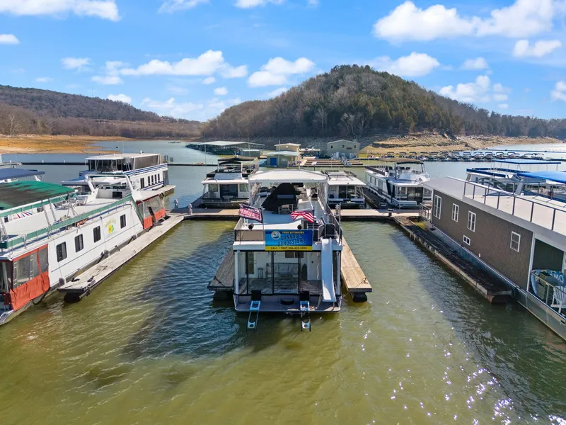 Slide: The Image of 2011 Horizon 18 X 82 Houseboat docked in scenic marina with surrounding hills. - 9