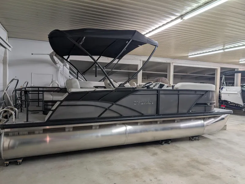 Slide: The Image of 2025 Sylvan Mirage 8522 CLZ pontoon boat in indoor storage facility. - 0