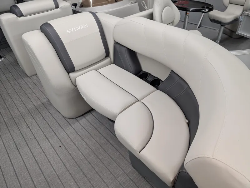 Slide: The Image of 2025 Sylvan Mirage 8522 CLZ boat interior with plush seating and modern design. - 4