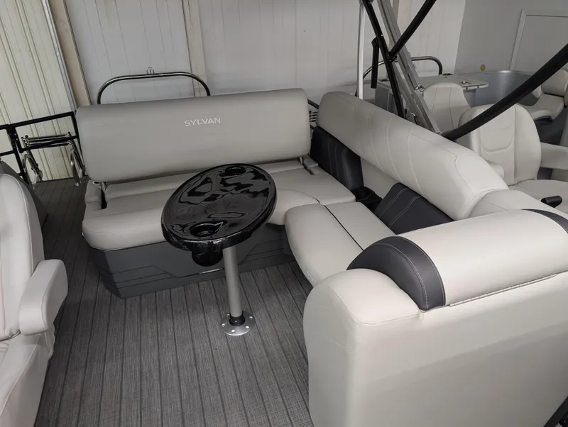 Slide: The Image of 2025 Sylvan Mirage 8522 CLZ interior with gray seating and a black table. - 5