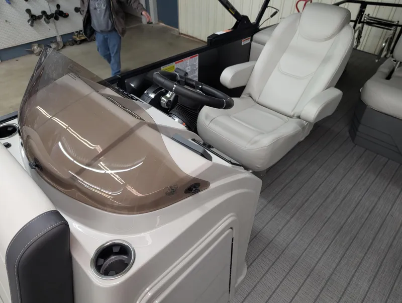 Slide: The Image of 2025 Sylvan Mirage 8522 CLZ boat interior with captain's chair and steering console. - 6