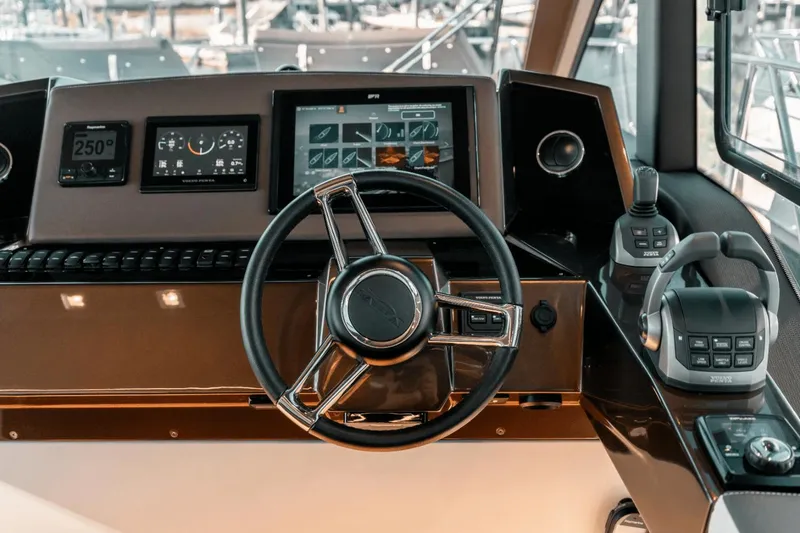 Slide: The Image of 2024 Galeon 425 HTS helm with modern navigation controls and steering wheel. - 19