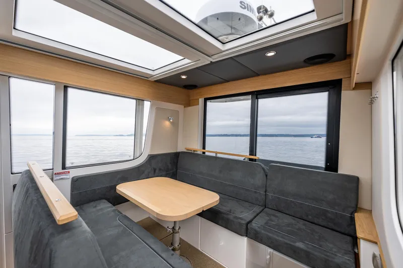 Slide: The Image of Interior of 2022 Nimbus C11 boat with spacious seating and ocean view. - 11