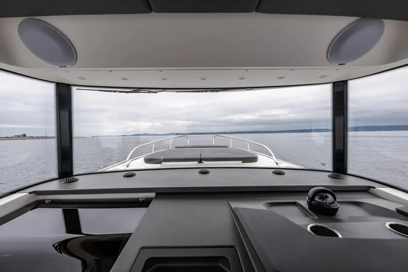Slide: The Image of Interior view from a 2022 Nimbus C11 boat, overlooking calm waters. - 18