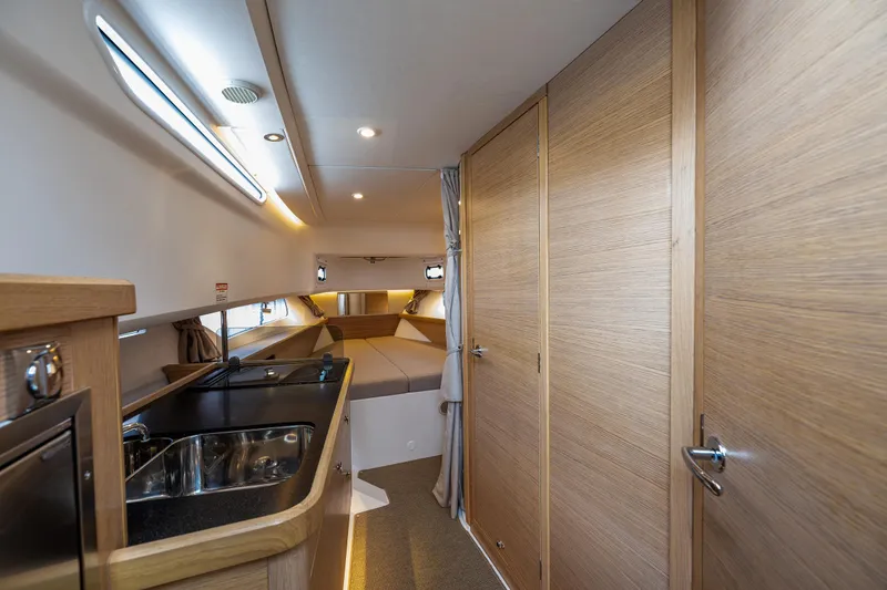 Slide: The Image of Interior of 2022 Nimbus C11 boat with modern kitchen and cozy sleeping area. - 19