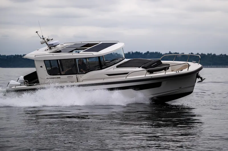 Slide: The Image of 2022 Nimbus C11 boat cruising on water, showcasing sleek design and modern features. - 3