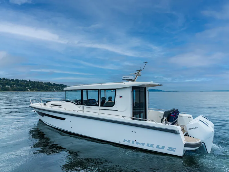 Slide: The Image of 2022 Nimbus C11 boat on calm water under a clear blue sky. - 30