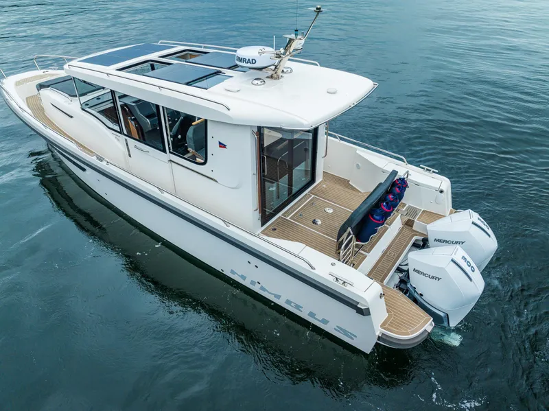 Slide: The Image of 2022 Nimbus C11 boat with dual Mercury engines on calm water. - 31