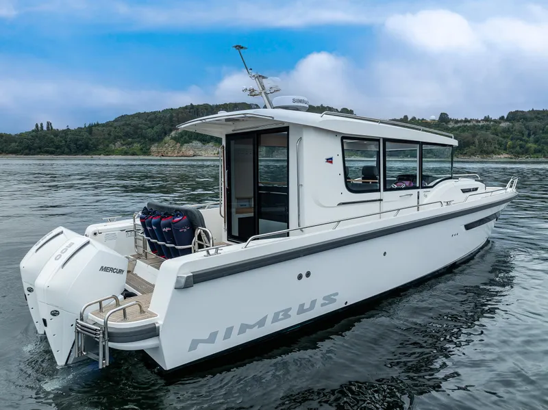 Slide: The Image of 2022 Nimbus C11 boat on water, featuring sleek design and powerful Mercury engines. - 35