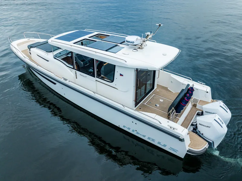 Slide: The Image of Nimbus C11 2022 boat on calm water, featuring sleek design and twin outboard engines. - 36