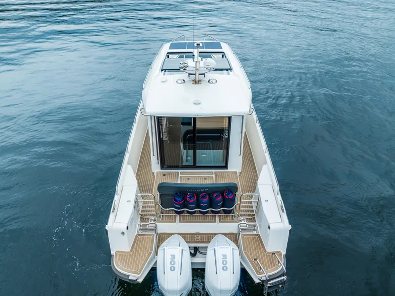 Slide: The Image of 2022 Nimbus C11 boat on water, rear view with twin engines. - 39