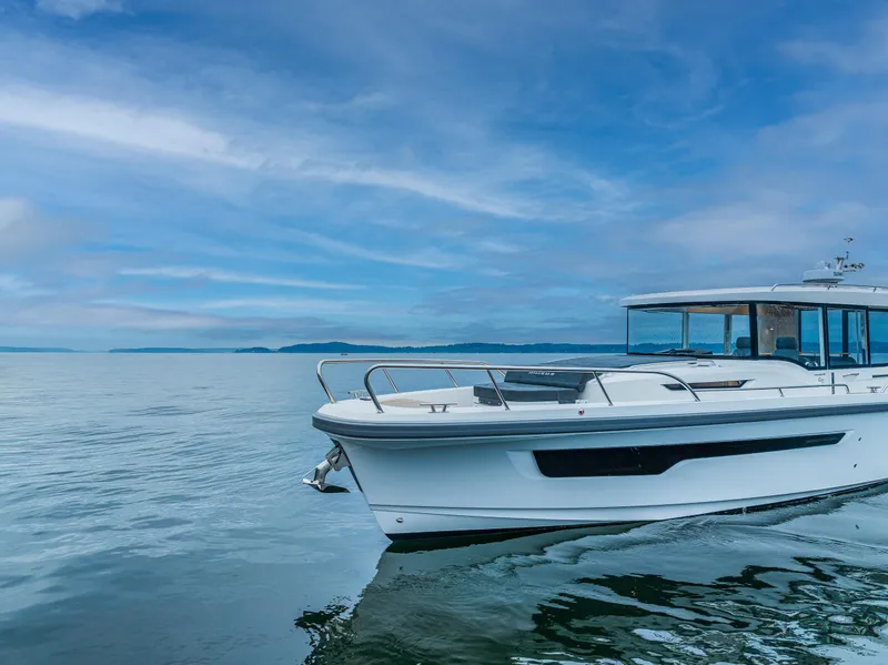 Slide: The Image of Nimbus C11 2022 boat cruising on a calm sea under a blue sky. - 40