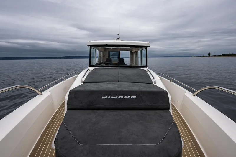 Slide: The Image of 2022 Nimbus C11 boat on calm water under cloudy sky. - 6