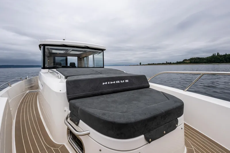 Slide: The Image of Nimbus C11 2022 boat on calm water, featuring sleek design and spacious deck. - 7