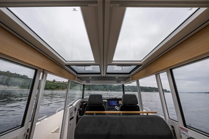 Slide: The Image of Interior view of 2022 Nimbus C11 boat with panoramic windows and modern dashboard. - 9