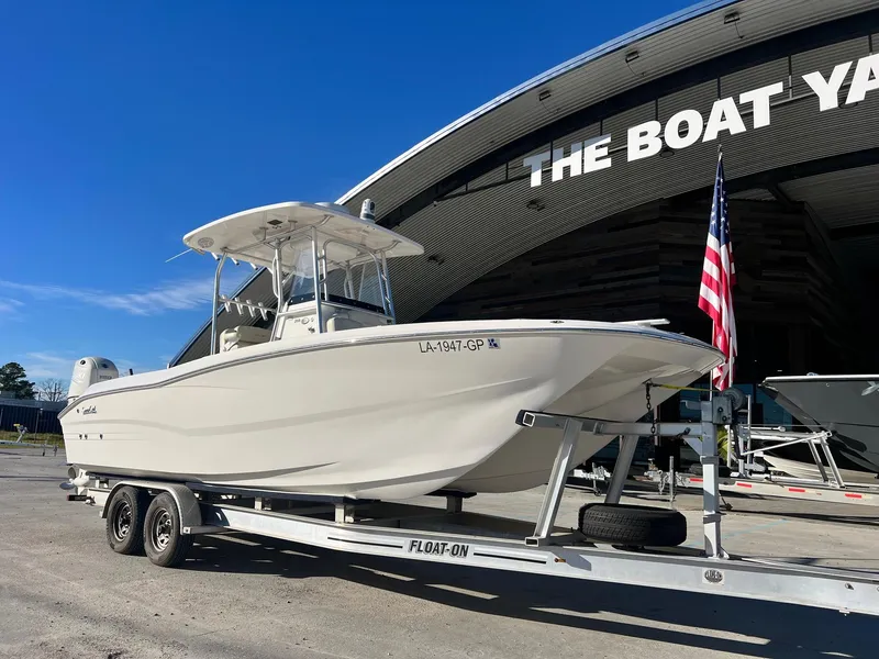 Slide: The Image of 2019 Sea Cat 260 boat on trailer at The Boat Yard, American flag visible. - 1
