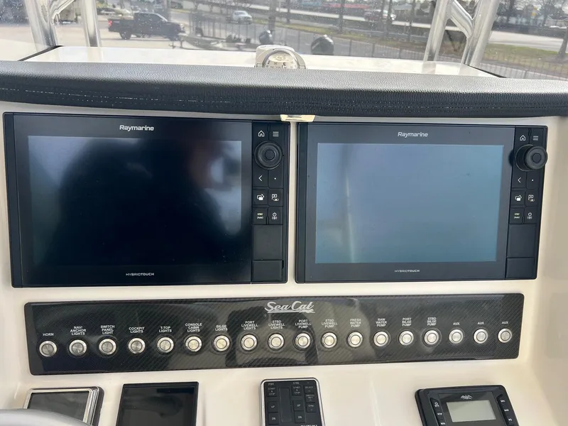 Slide: The Image of Control panel of 2019 Sea Cat 260 with dual Raymarine displays. - 16