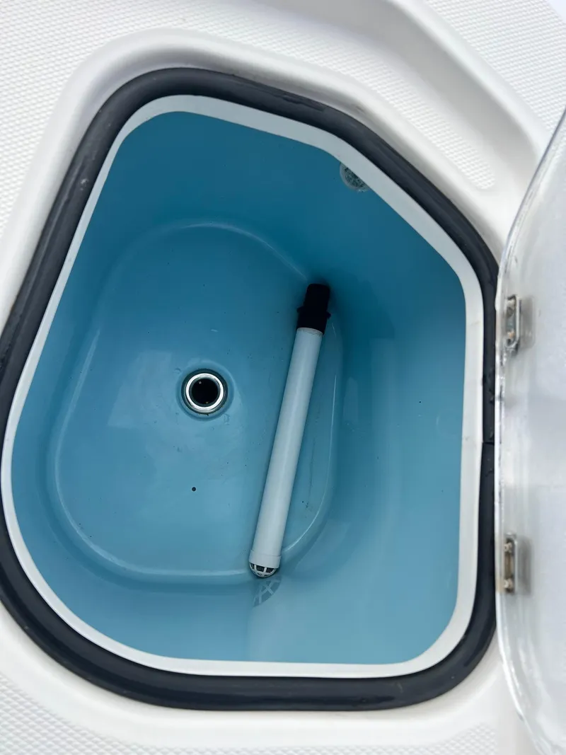 Slide: The Image of Livewell compartment of a 2019 Sea Cat 260 boat, featuring a drain and aerator tube. - 21
