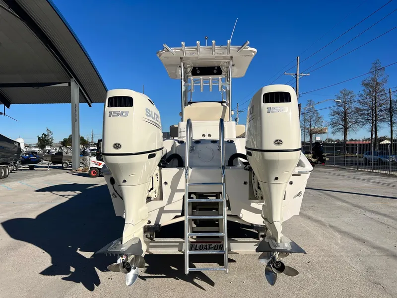 Slide: The Image of 2019 Sea Cat 260 boat with dual Suzuki 150 engines, parked outdoors. - 4