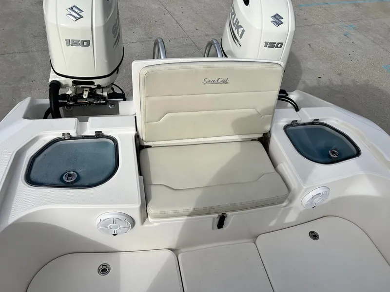 Slide: The Image of 2019 Sea Cat 260 boat with dual Suzuki 150 engines and cushioned seating. - 7