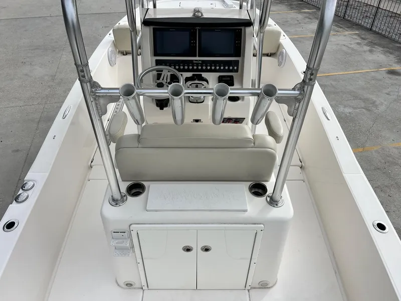 Slide: The Image of 2019 Sea Cat 260 boat interior with steering console and rod holders. - 9