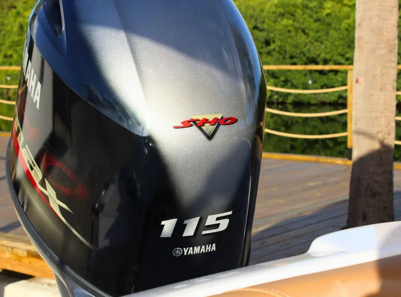 Slide: The Image of Yamaha 115 outboard motor on 2024 NauticStar 193 SC boat, dockside view. - 12