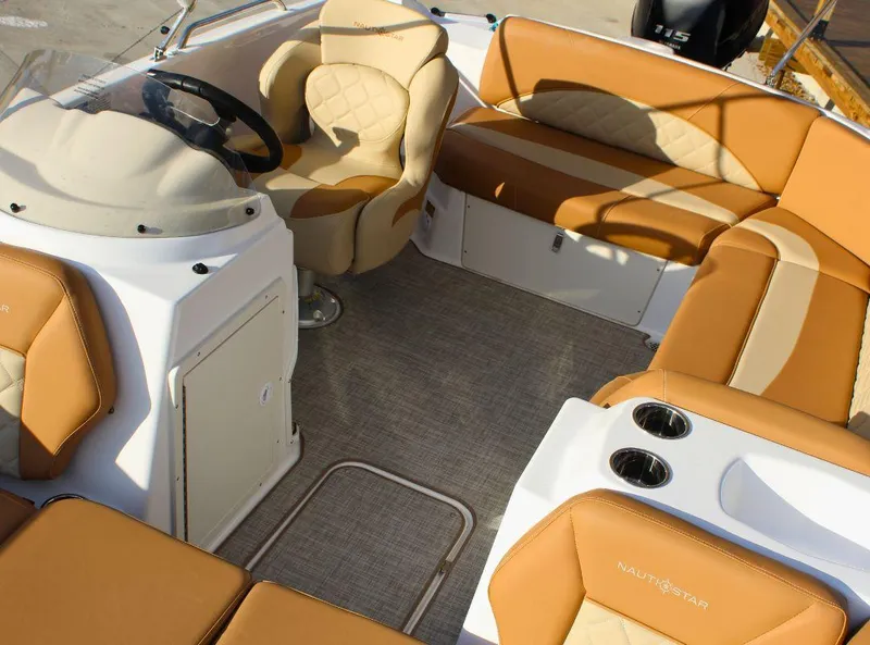 Slide: The Image of 2024 NauticStar 193 SC boat interior with tan seating and steering wheel. - 18