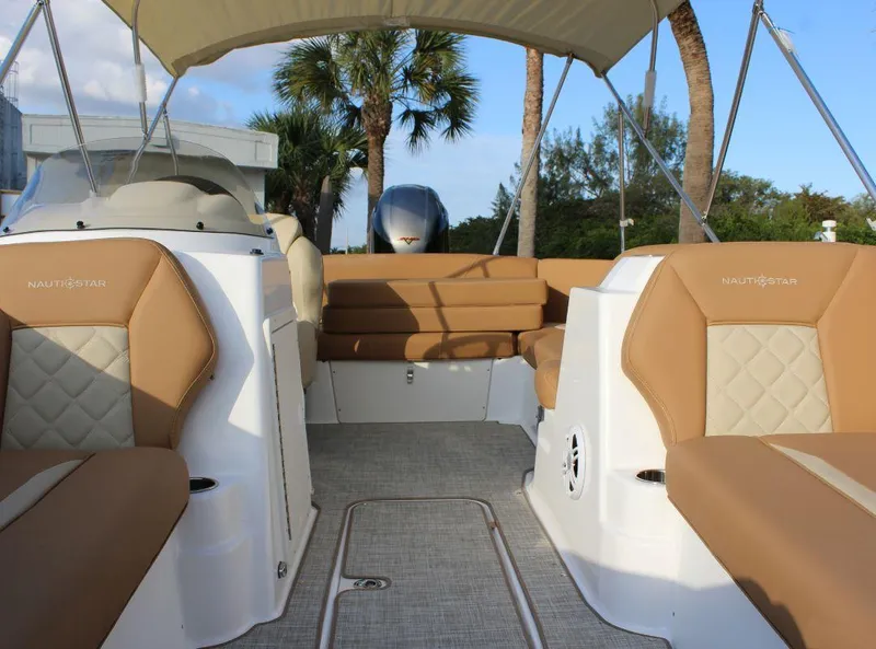 Slide: The Image of 2024 NauticStar 193 SC boat interior with tan seating and canopy. - 20